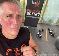 Banner with Phoenix Boxing logo beside exercise equipment