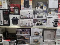 Shelves of boxed small appliances at Rideau Auctions Liquidation Centre