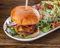 Burger and salad representing NOX Eatery menu