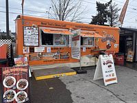 Orange Fat Les' Chip Stand food truck exterior