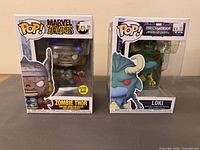 Front view of both boxed Funko Pop figures: Zombie Thor and Mech Strike Loki
