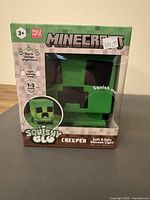 Front view of boxed Minecraft Creeper Squish Glo silicone light