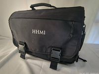 Front view showing HHMI logo, flap, buckles