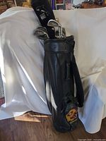 Full view of leather golf bag with clubs inserted