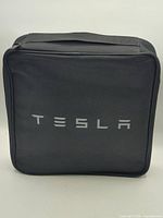 Front exterior showing Tesla logo and overall condition