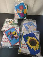 All four sealed Emson flags showing each design