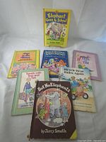 Seven books laid out showing titles and covers