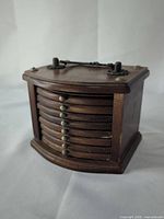 Holder closed showing brass accents and chain handle