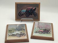 All three wood-mounted lithograph plaques on stand and flat