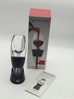 Aerator on stand beside box and manual