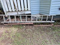 Full length of ladder against porch, shows entire item