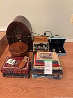 Group shot showing radio cabinet, books, wood boxes, watches and knife set