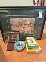 Group shot shows framed print, collage frame, plates and book stack