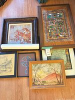 Group shot of all six artworks showing frames and rolled poster