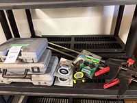 overall lot on shelf showing cases, clamps, packaged items