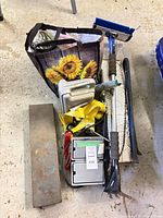 Group view showing snow brush, pry bar, ratchet straps, storage boxes, sunshade, steel plate and tote
