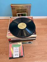 Overall lot showing stacked LPs, loose record on top, CDs at front