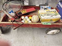 Wagon loaded with model kit, balls, racket, shovel visible