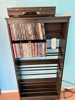 Front view of media shelf with Sony player and DVDs