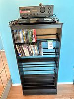 Full view of media shelf with electronics and discs