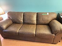 Front view of brown leather 3-seat sofa