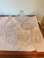 Group shot of all nine cut glass pieces on table