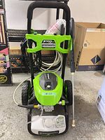 Full view of Greenworks 2100 PSI pressure washer with wand and hose