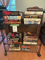 Full view of three-tier rolling stand loaded with Stephen King books