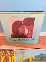Nat King Cole album with partial view of Tom T. Hall cover
