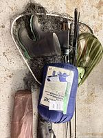 Overview of lot showing rods, nets, boots, sleeping bag, gear bags