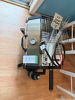 Grill with accessories stacked on top