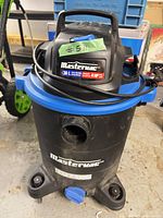 Full view of Mastervac canister vacuum on casters