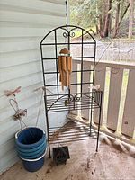Full view of plant stand with wind chime, buckets and stakes