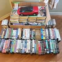 Full view showing box of tapes, rows of tapes, and car-shaped rewinder