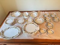 Full dinnerware set laid out on table