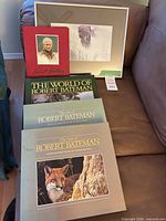Group shot showing four Robert Bateman books and framed bird print