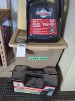 Full view showing gear oil jug on tote, chain case beneath