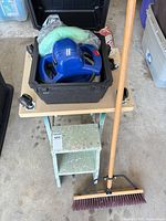 Lot overview showing polisher in case on step stool, broom, dolly