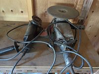 Both grinders with cords and accessories on bench