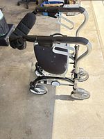 Side view of rollator showing frame, wheels and seat