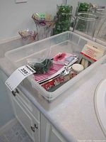 Overview of bin with vases and bag of gems