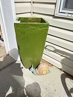 Full view of planter with snail in front