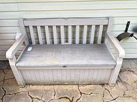 Front view of storage bench against siding