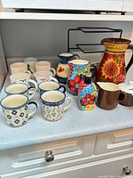 Full group shot showing mugs, pitchers and dispenser