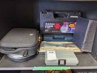 All items on shelf: SCC radial chains case, thread repair kit case, rivet gun kit, fabric carrying case, technical manual