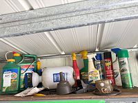 Shelf with pump sprayer, spray bottles, insecticide cans
