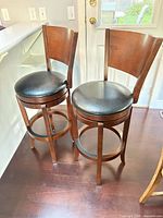 Front view showing both bar stools, materials and finish