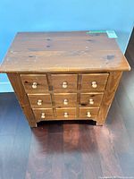 Front view of solid wood chest showing three drawers and knobs