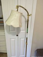 Full view of lamp showing adjustable arm and shade