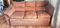 Front view of brown microfiber 3-seat sofa